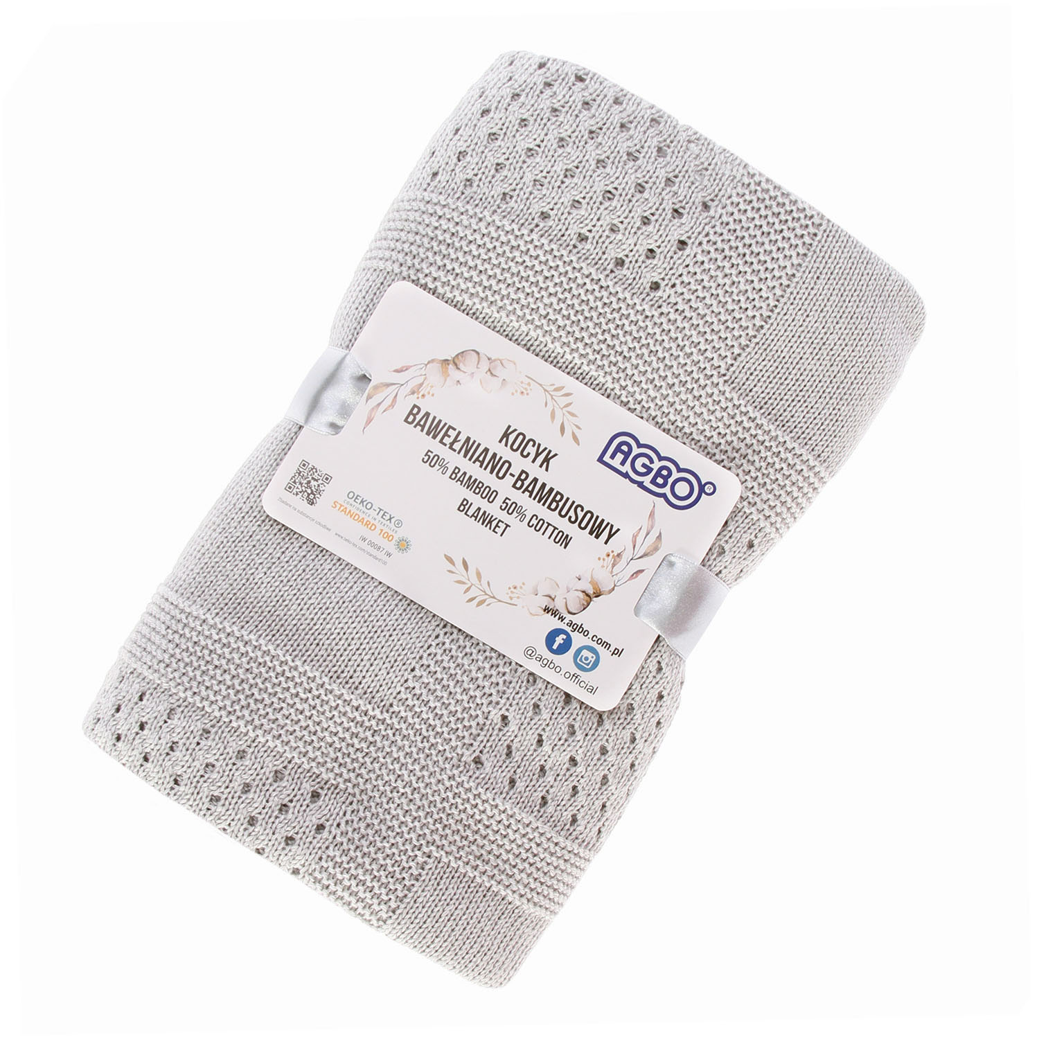 Elegant gefaltete Babydecke in Grauton – liebevoll als Geschenk für Neugeborene vorbereitet